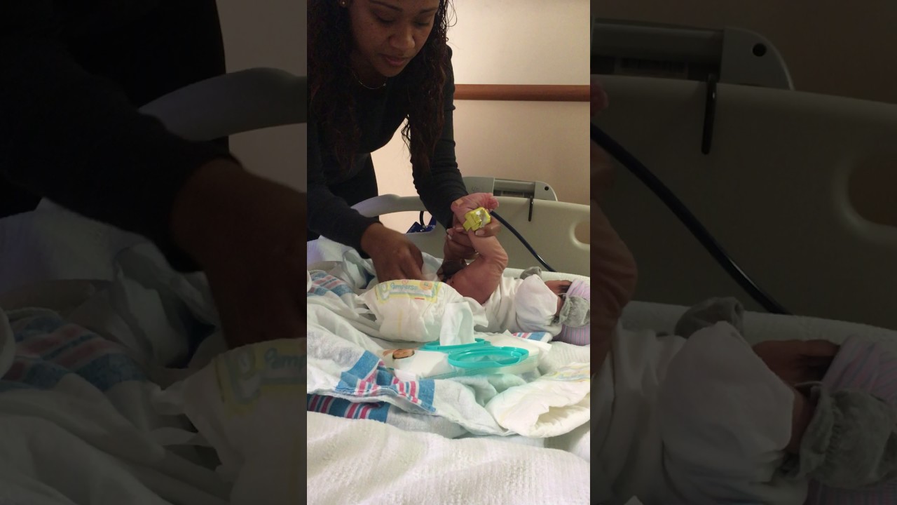 Daddy changing Kam's first diaper