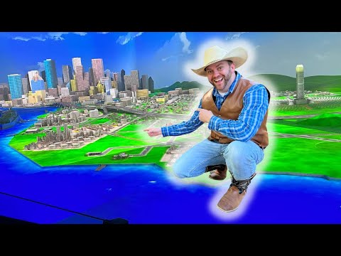 Cowboy in a blue plaid shirt points at a glowing 3D city map with green land and blue water, smiling at the scene.