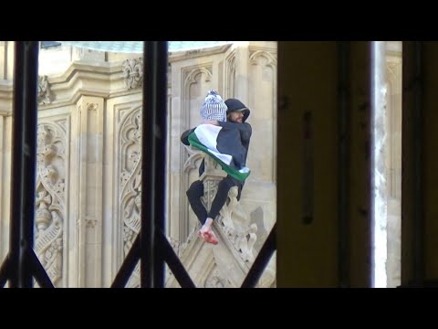 Video Thumbnail: Man with a Palestinian flag perches on the side of Big Ben tower | AFP