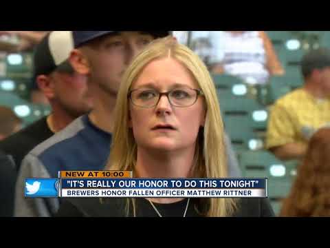 Slain MPD officer's wife throws out first pitch at Brewers game