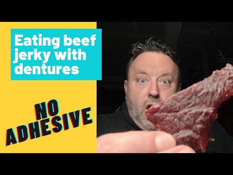 Eating with dentures. Eating beef jerky with dentures,...