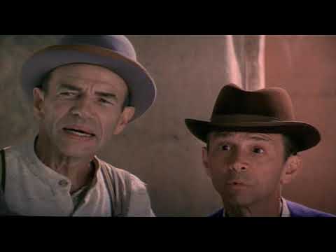 Official trailer frame for The Fantasticks (2000) with carnival lights and El Gallo’s shadowed silhouette