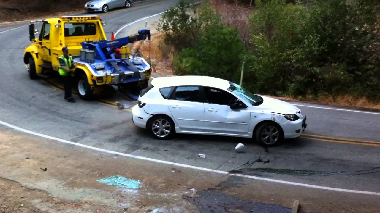 Video: Tow truck driver makes crash even worse by rolling car off the ...