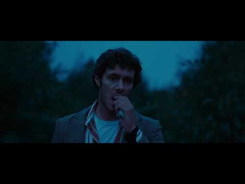The Kid Detective (2020) trailer still with Adam Brody as Abe Applebaum walking past small-town storefronts