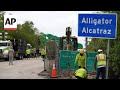 Workers install 'Alligator Alcatraz' sign for Florida immigration detention center