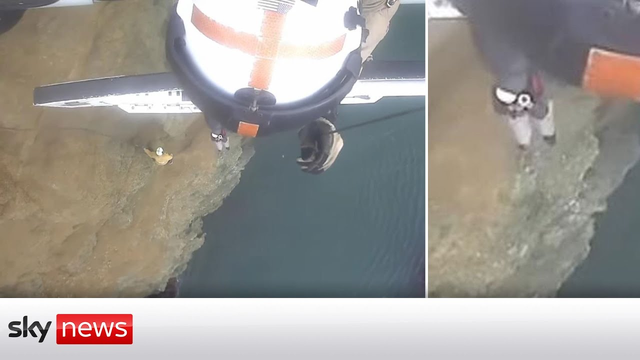 Watch moment helicopter rescues two people stranded on cliff edge