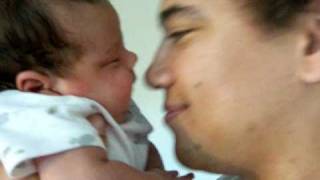 Baby sucking on dad's  nose