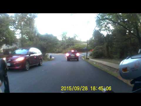 Passing a cyclist with an oncoming car on a residential street...