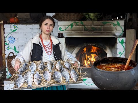 Hard life in village. Woman is cooking traditional Ukrainian food in oven. 300 year old recipes