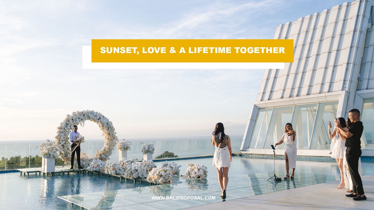 Video thumbnail: proposal on a white infinity-pool platform with a flower arch and photographers