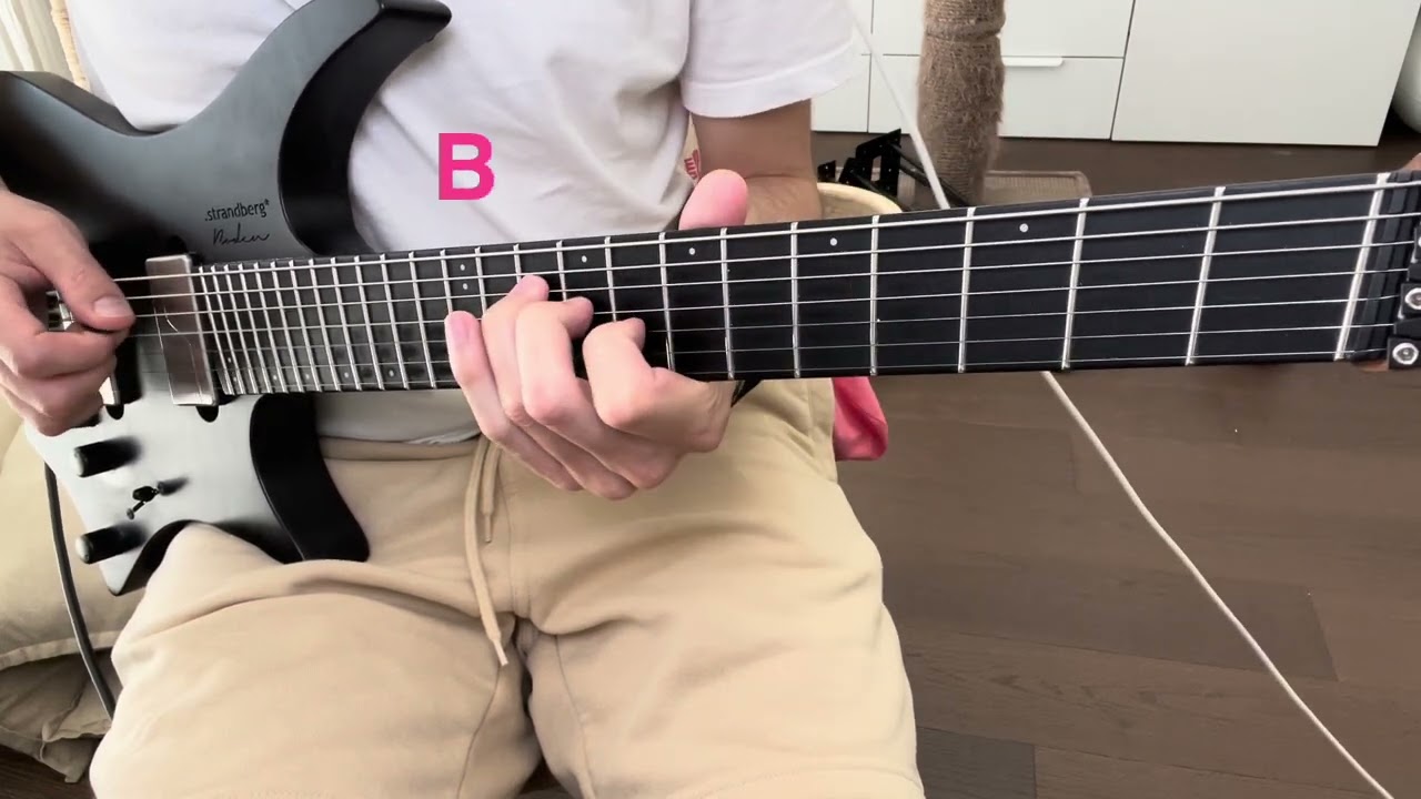Guitarist playing augmented triads on the G, D and A strings in a voice-leading exercise