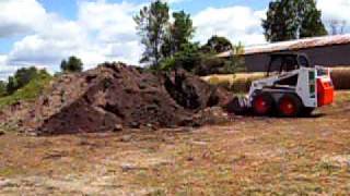 preview picture of video 'Bobcat cleaning up around the topsoil pile'