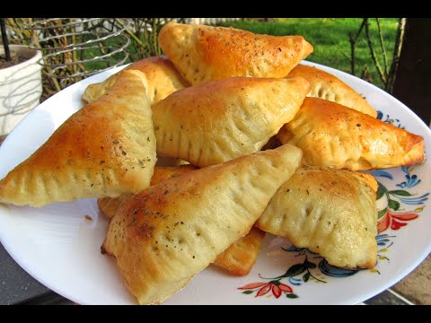 baked DUMPLINGS MADE OF YEAST AND COD CHEESE DOUGH stuffed with mushrooms and cheese, delicious a...