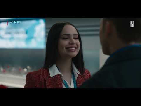 Carry-On trailer shot of a tense phone call inside a decorated airport concourse