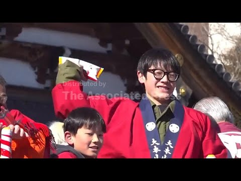 Hundreds reach out to catch lucky beans at Japan's annual festival - YouTube