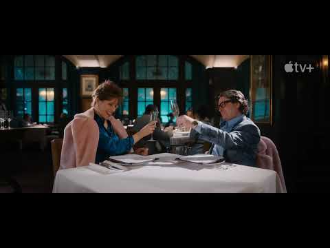 Trailer close-up: neon-lit handshake in a club—deal-making with a soundtrack