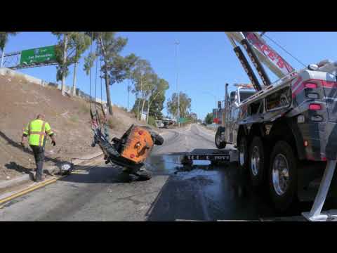 Overturned asphalt trailer = sticky mess on freeway