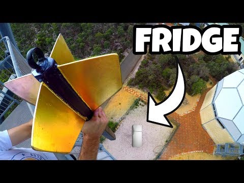 YouTube thumbnail showing a person on a high platform holding a yellow winged contraption, with a fridge on the ground below and the word FRIDGE in bold text.