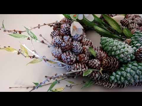 Winter door wreath made of natural materials and crepe paper Snowdrop flowers.