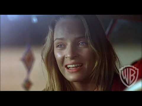 Original theatrical trailer frame for Even Cowgirls Get the Blues with Uma Thurman hitchhiking on a highway