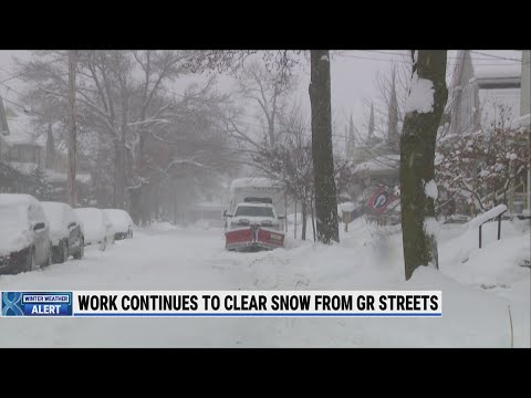 As Grand Rapids plows clear streets, parked cars hinder work