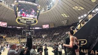 Zach Edey watches senior day intro video w/parents