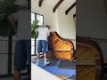 One man setting up grand piano ￼