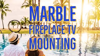 TV mount installation on a marble wall above fireplace