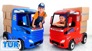 Vlad ve Nikita çocuklar için kamyonlarla oynuyor