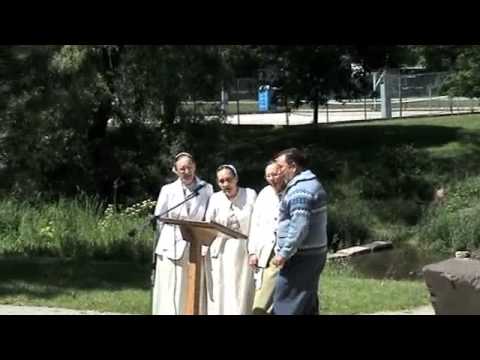 The Schwartz Family singing at baptism in the park