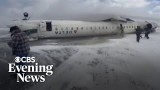 Images show Delta Air Lines plane upside down after crash landing at Toronto airport