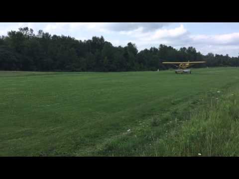Launching a 1947 Piper J-3 Cub seaplane from a cart off of a grass runway