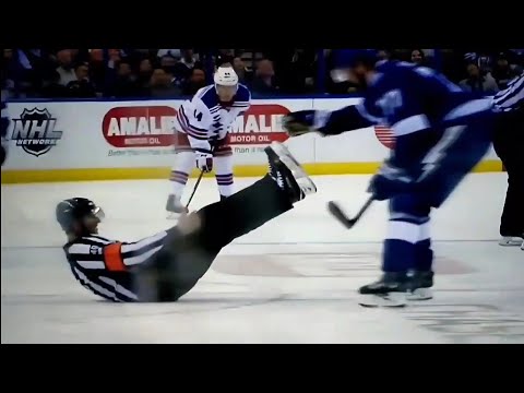 NHL Referee Steve Kozari goes for a tumble