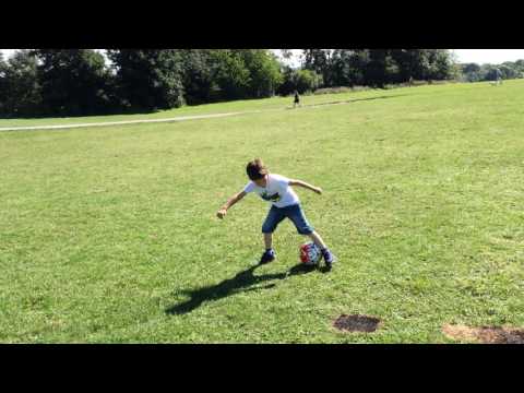 Top goal scorer 6 year old boy dribbling ball