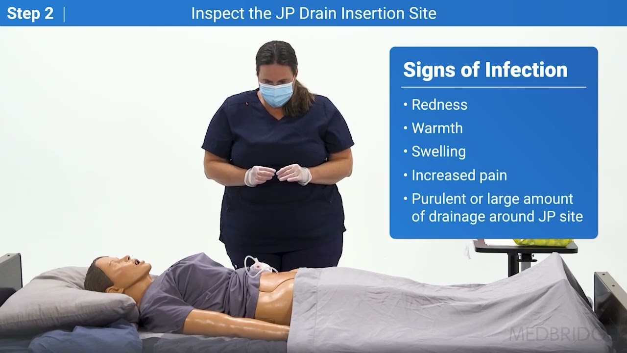 A healthcare worker uses medbridge software to learn about JP drain infection signs on a patient mannequin.