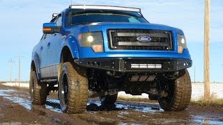 Lifted Ford F-150 4x4 hits a Mud Puddle on Icy Dirt Road