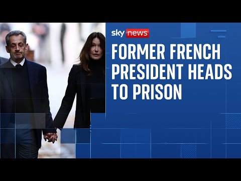 Nicolas Sarkozy walks with Carla Bruni on way to begin five-year prison term