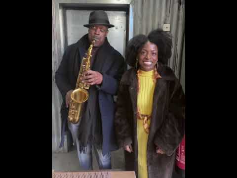 Carol poses with Saxophonist Wadada at 'A Taste of Salsa' Caribbean Roast!