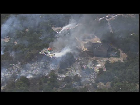 Firefighters battle brush fire on the far northside