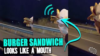 Guy Holds a Burger Sandwich Out of Car’s Window as Air Makes the Components Flip