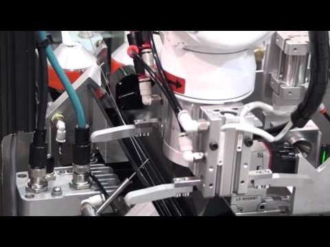 Robotic loading a Guidewire on a Royal Master Centerless Grinder