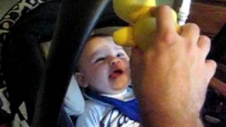 Easton talking to his little birdie toy