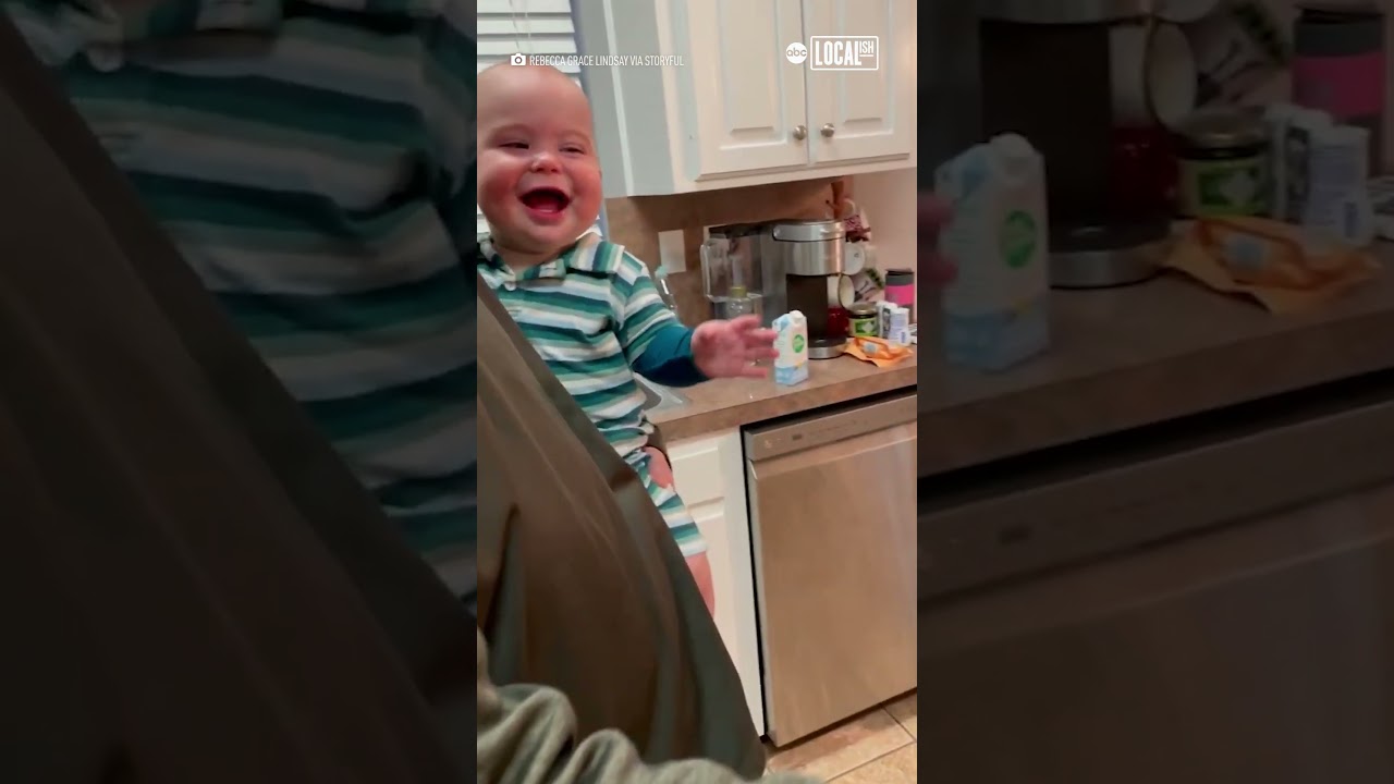 Giggling baby throws head back in laughter