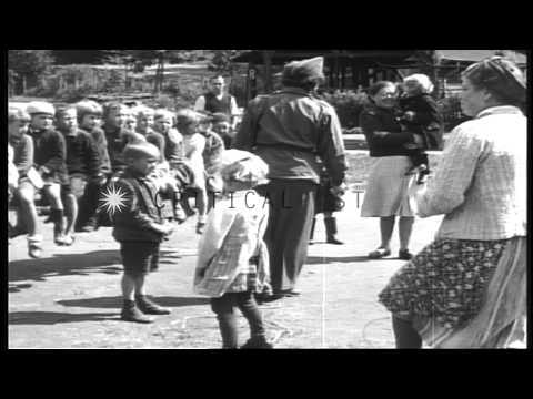 Children play with the adult displaced persons under the direction of UNRRA worke...HD Stock Footage