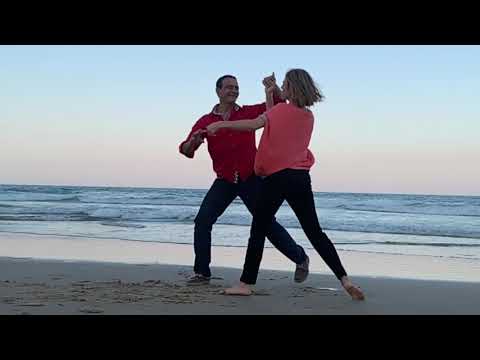 Dancing on the beach at sunset in slow motion