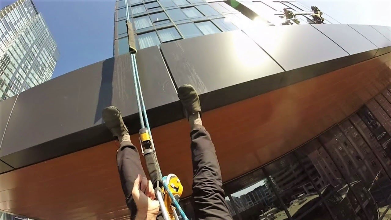 Rope access window cleaning with rigging and lots of the drop.