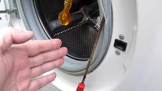 remove door lock from Beko washing machine by first removing spring retainer on rubber seal