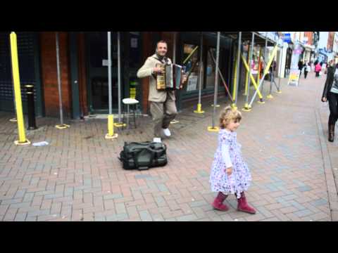 Toddler and busker dancing in the street!