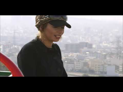 Official trailer frame: two young musicians weave through Tehran’s streets with a guitar case as city noise shimmers
