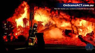 Firefighters battle building fire with large explosions north of Canberra
